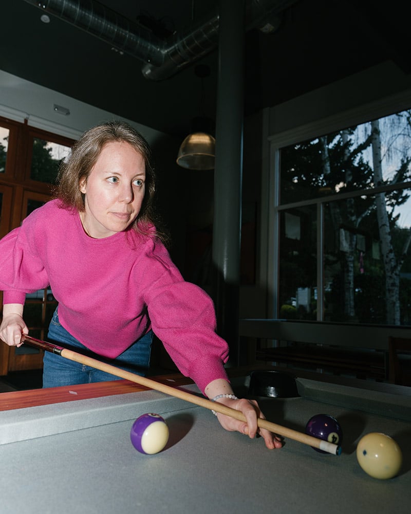 Molly playing billiards